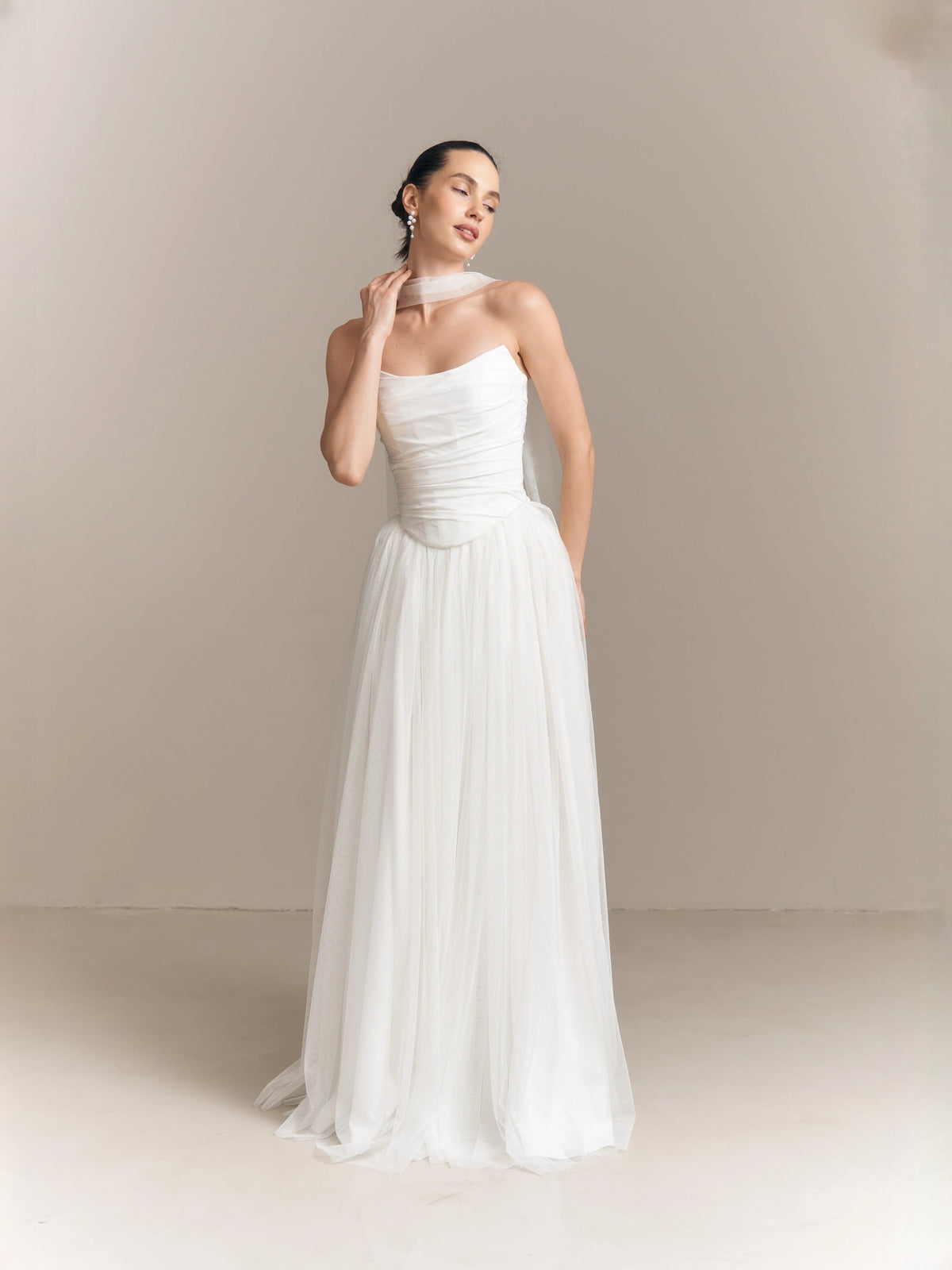 Ivory strapless A-line wedding dress with ruched bodice and gathered floor-length skirt