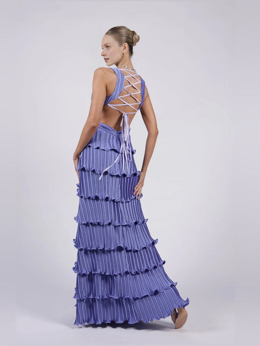 Purple v-neck pleated tiered formal dress with crisscross back straps, thigh slit, floor-length.