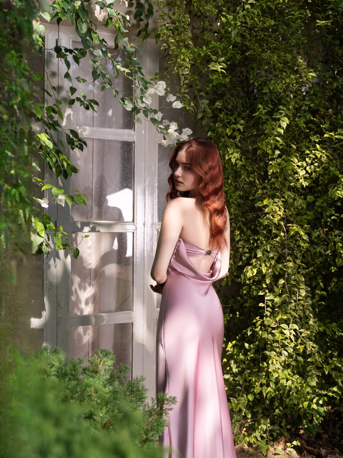 Dusty rose satin strapless draped sheath bridesmaid dress, side view, floor-length