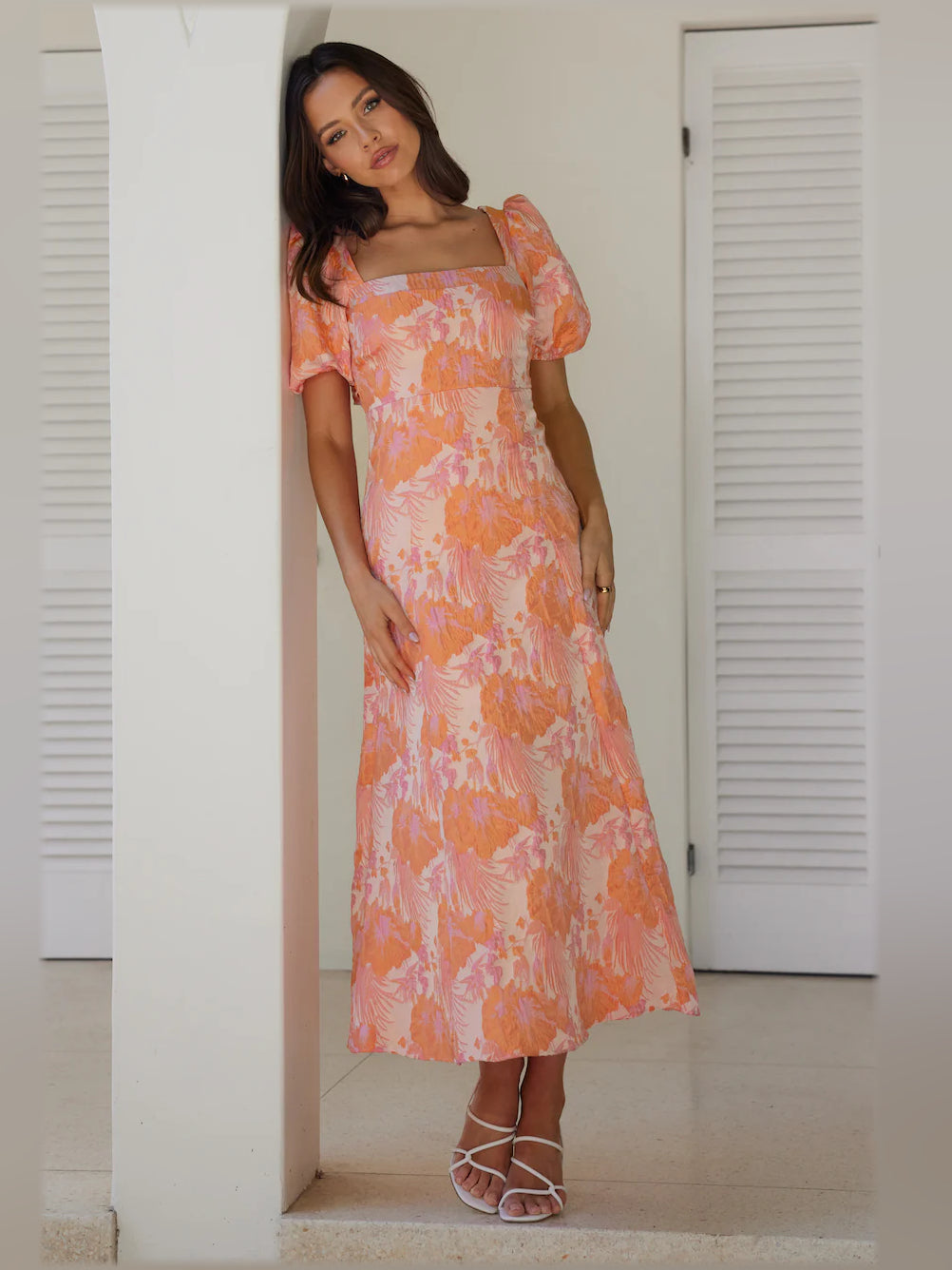 Coral-pink midi formal dress, square neckline and puff sleeves, fitted waist, side view