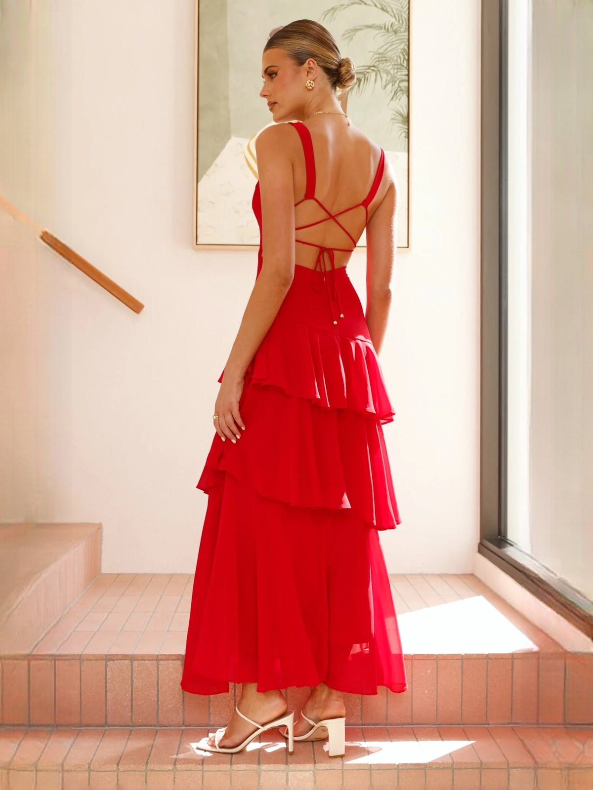 Red a-line maxi formal dress with tiered skirt, full-length back view