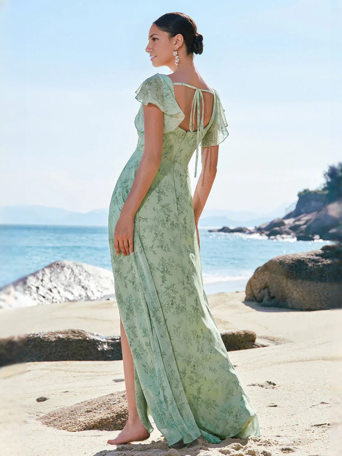 Mint green floral chiffon A-line maxi dress shown from the back with flutter sleeves