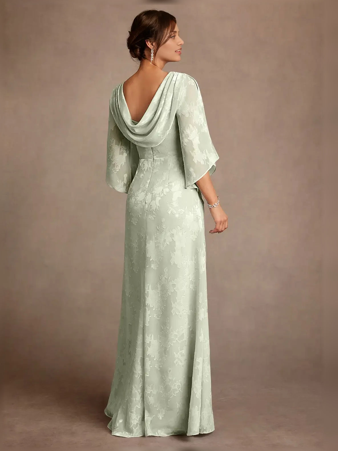 Mint green column dress with cowl drape back and three-quarter cape sleeves
