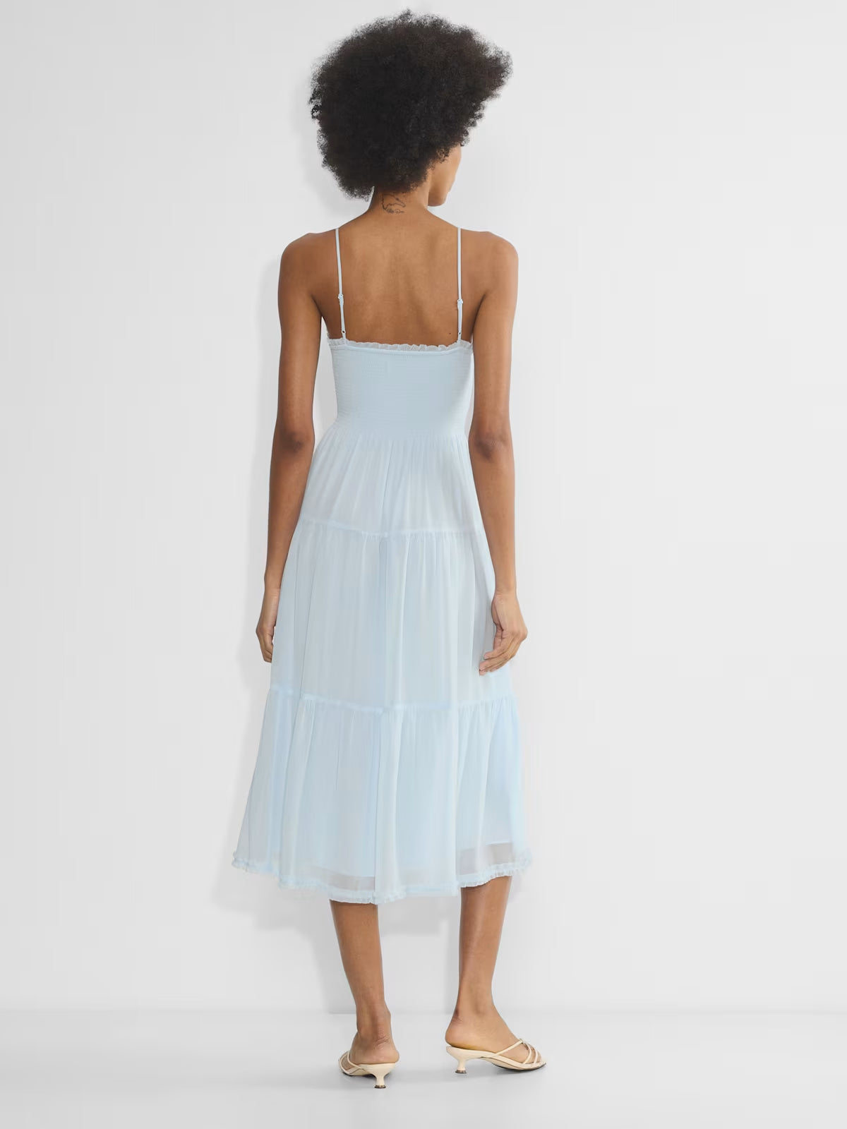Light blue chiffon midi dress with V-back, spaghetti straps, and tiered skirt