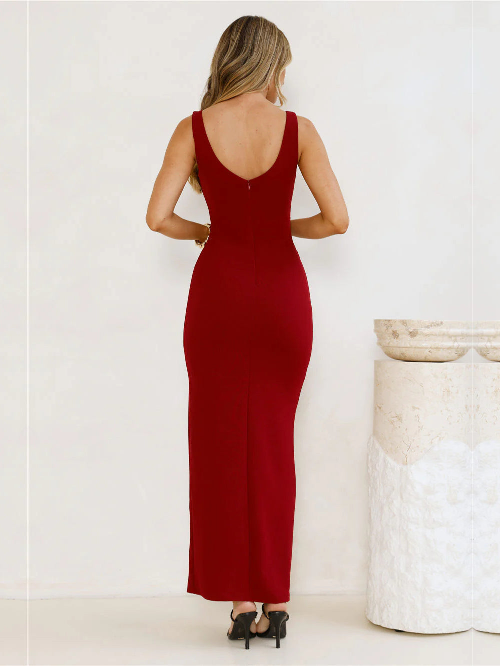 Burgundy sheath maxi formal dress with skirt slit, full-length back view