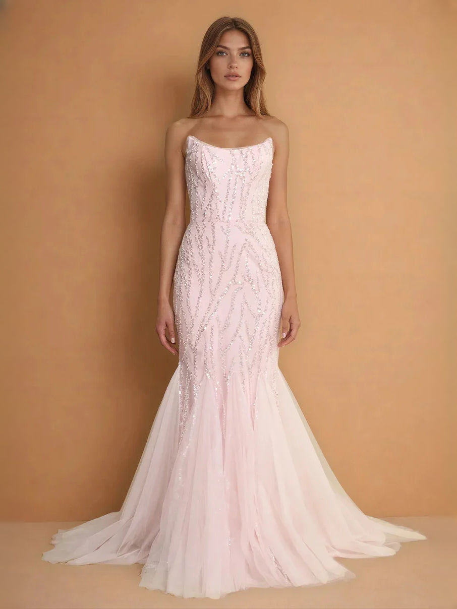 Blush pink strapless sequin mermaid prom dress with fitted corset and flared tulle hem