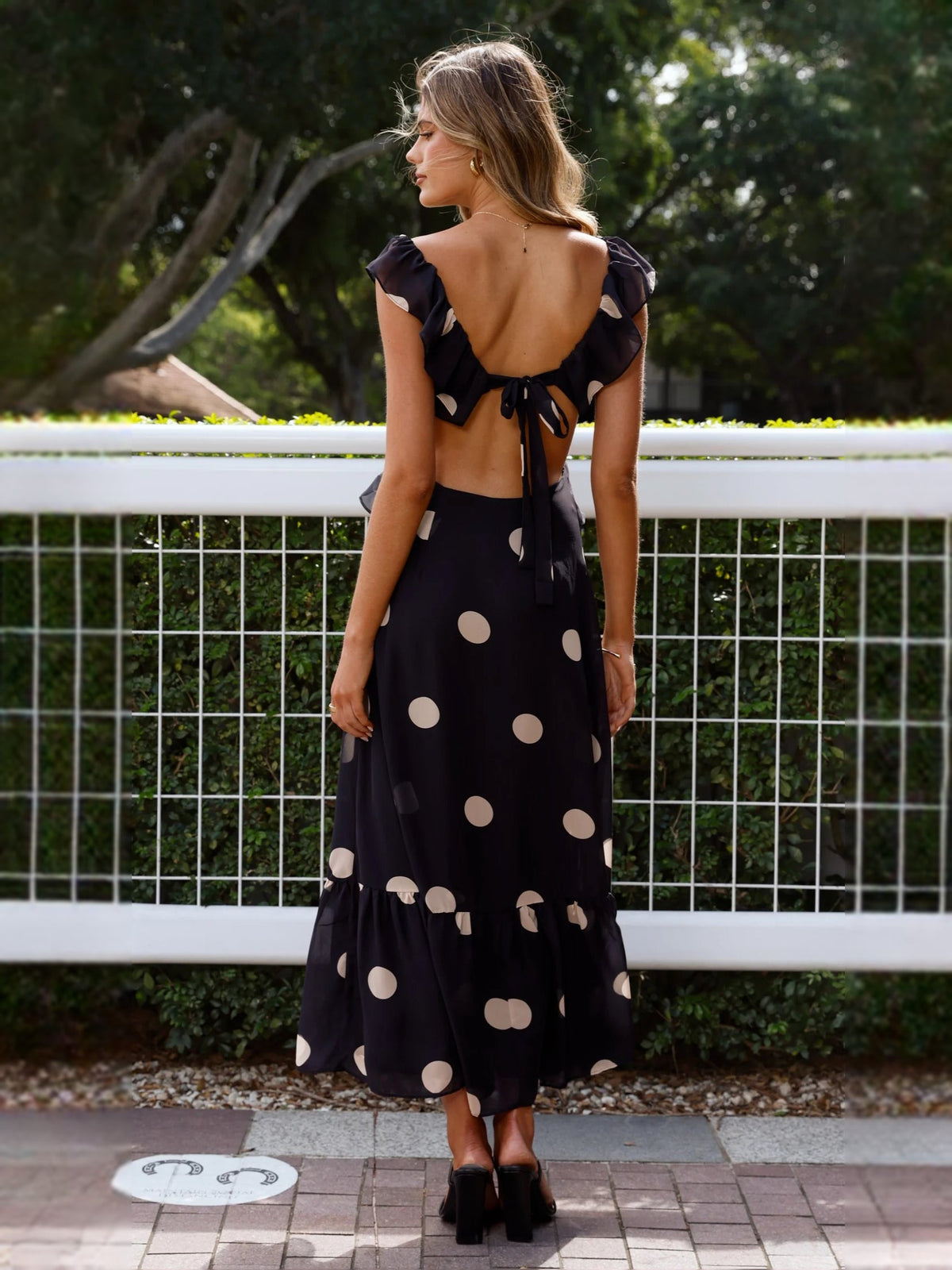 Black polka-dot midi dress, open-back with ruffled shoulders and tie straps