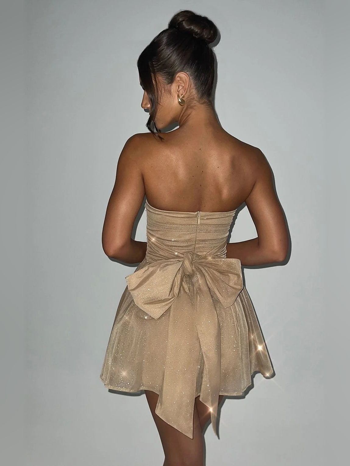 Mocha gold strapless mini dress, open back with tied bow and layered tulle skirt