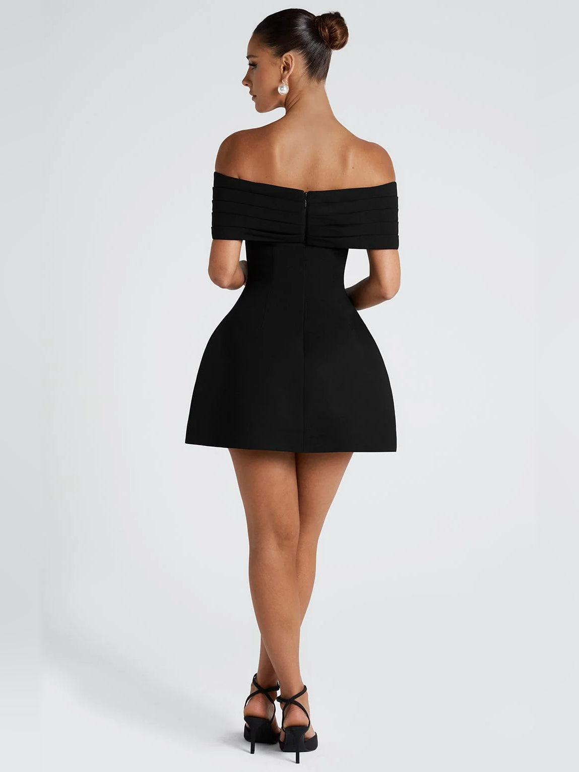 Black off-shoulder mini dress, back view with vertical seam detail