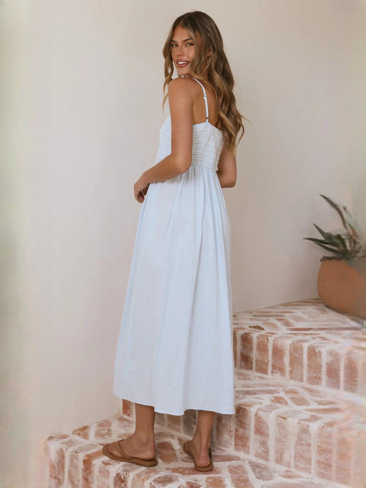 Light blue midi dress with spaghetti straps and flowy gathered skirt