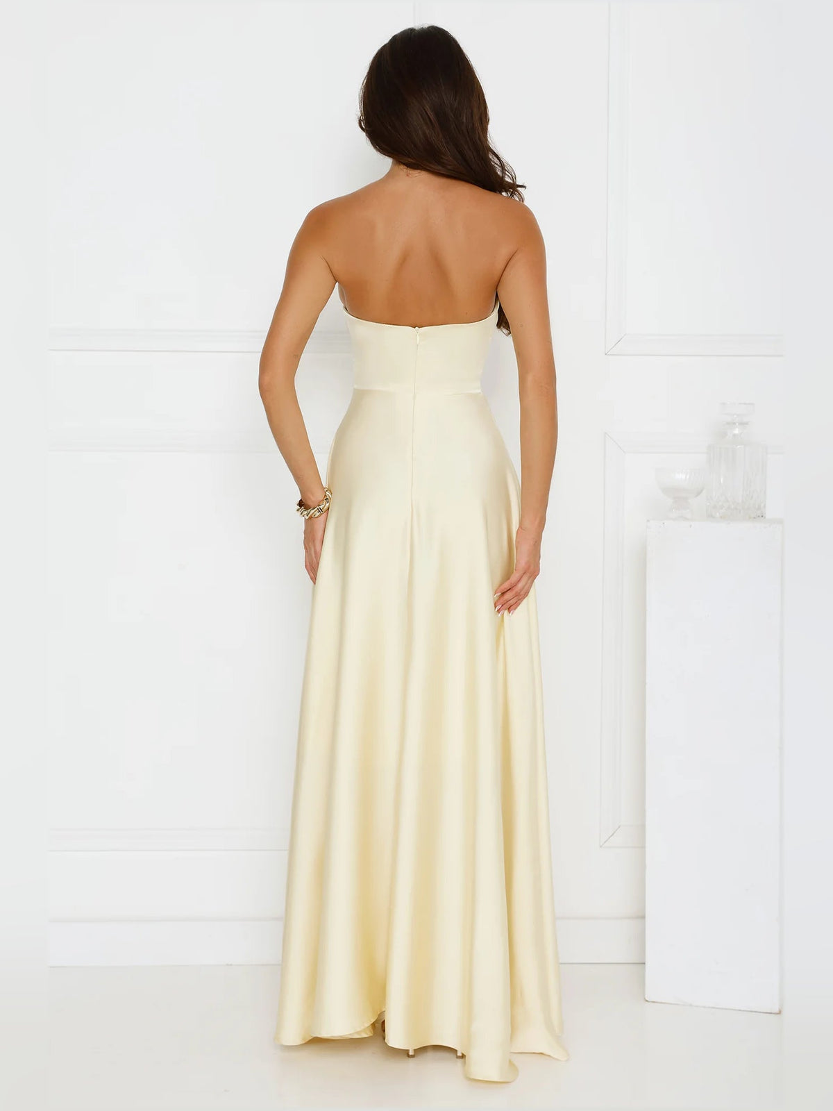 Yellow a-line maxi formal dress with skirt slit, full-length back view