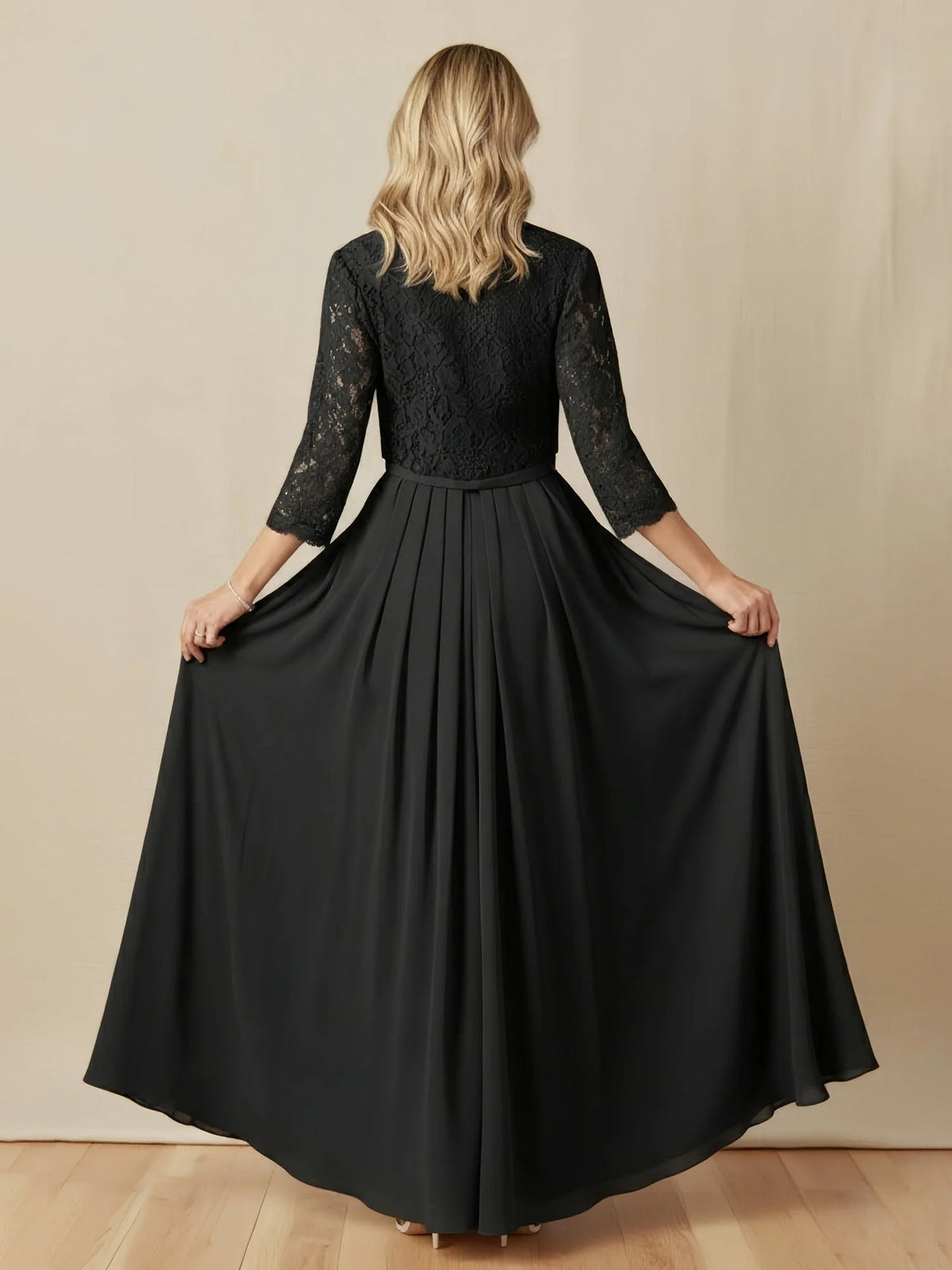 Black A-line dress back view, lace scoop back, beaded waist, full pleated skirt