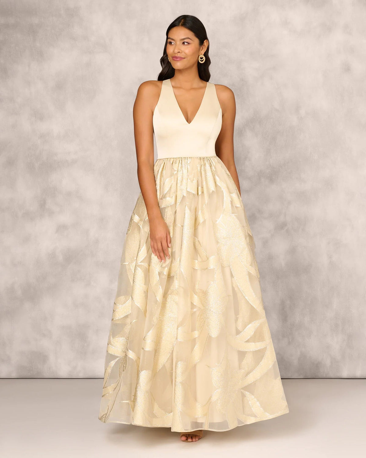 Gold V-neck sleeveless floor-length gown with beaded bodice and tiered skirt detail