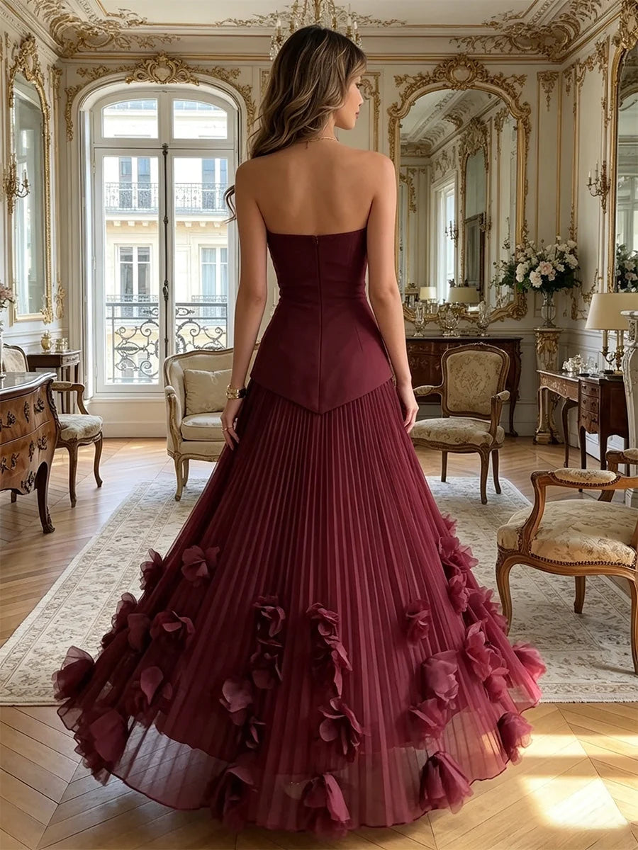 Deep red strapless A-line maxi gown with open back and layered ruffle skirt
