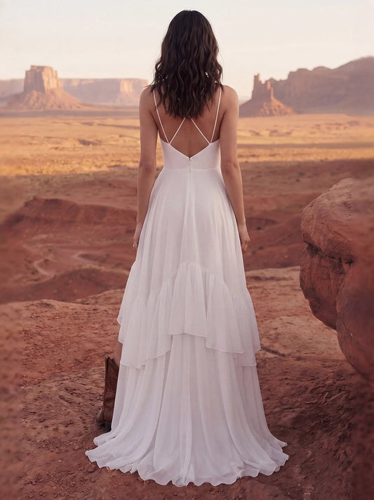 Ivory backless V-neck chiffon wedding dress with thin straps and tiered ruffle skirt