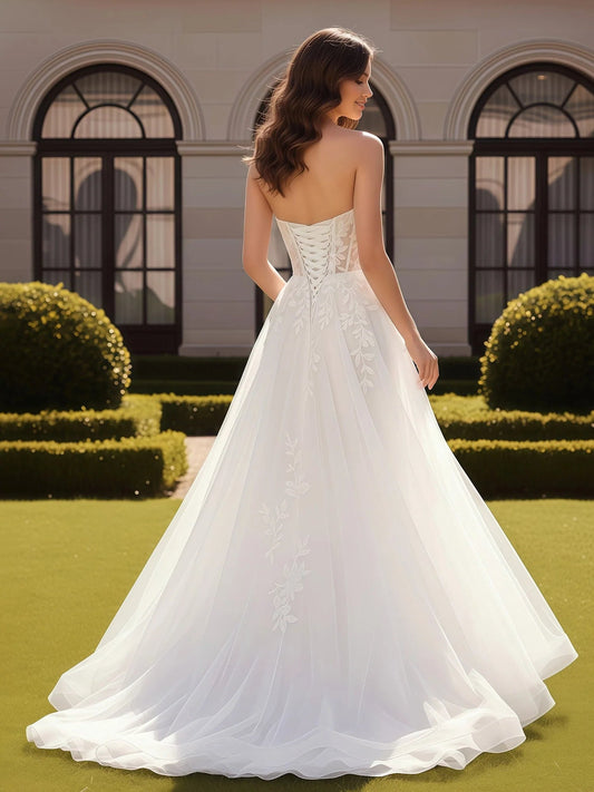 Ivory corset wedding dress with lace-back design and A-line tulle skirt, front slit