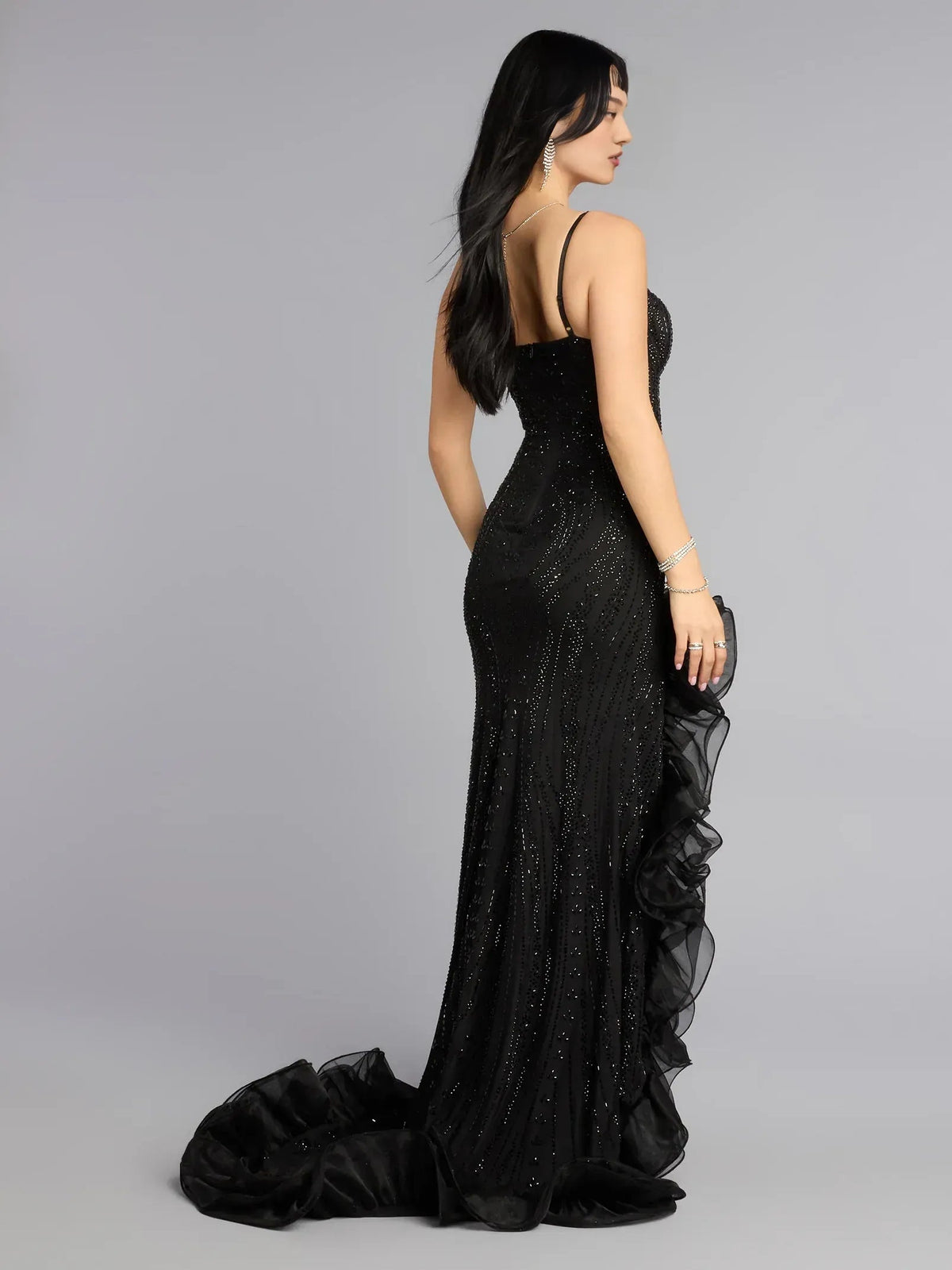 Black floor-length corset dress with spaghetti straps and layered ruffle skirt