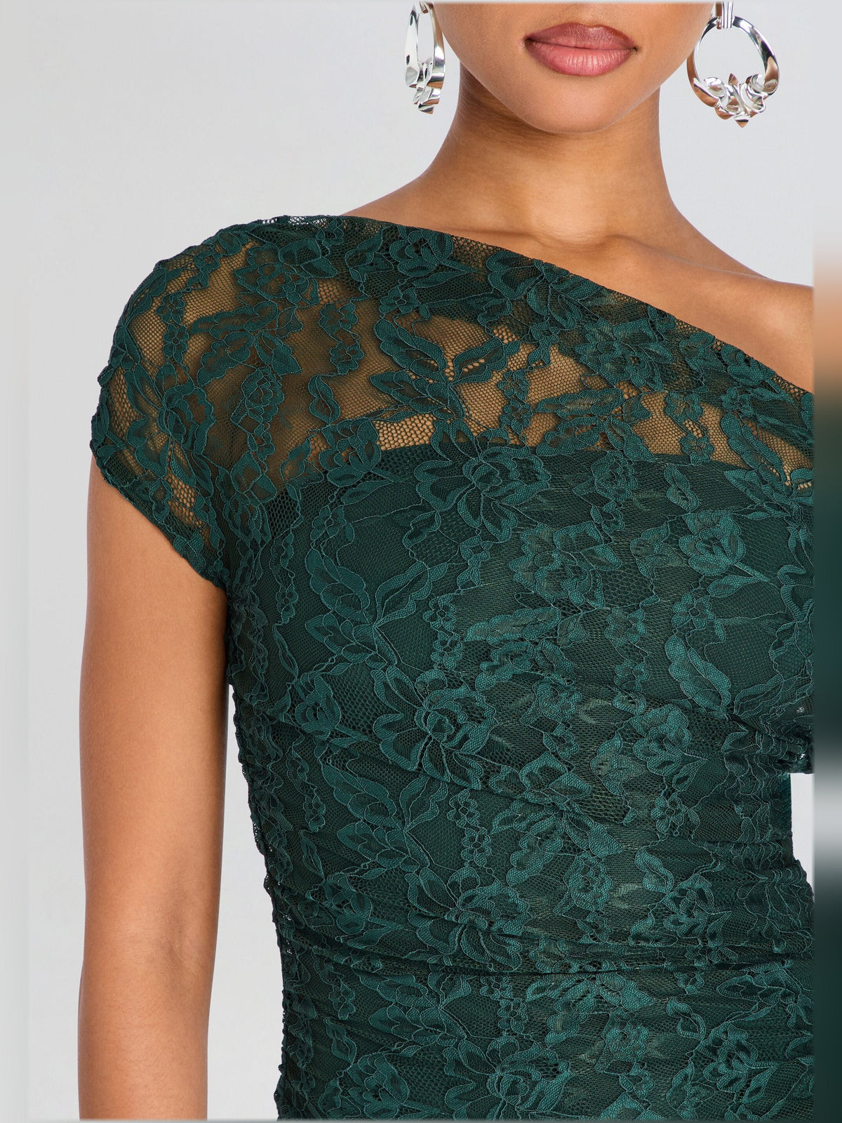 Teal lace bodice of a midi dress with floral texture and off-shoulder neckline