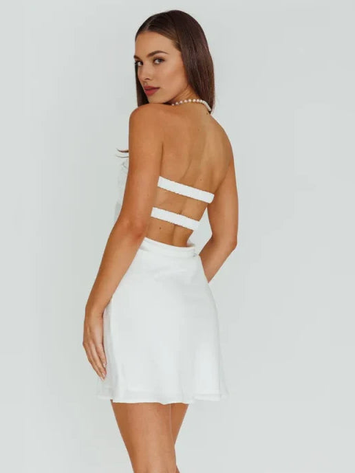 White satin mini dress, open back with crisscross straps and corset waist cut-out