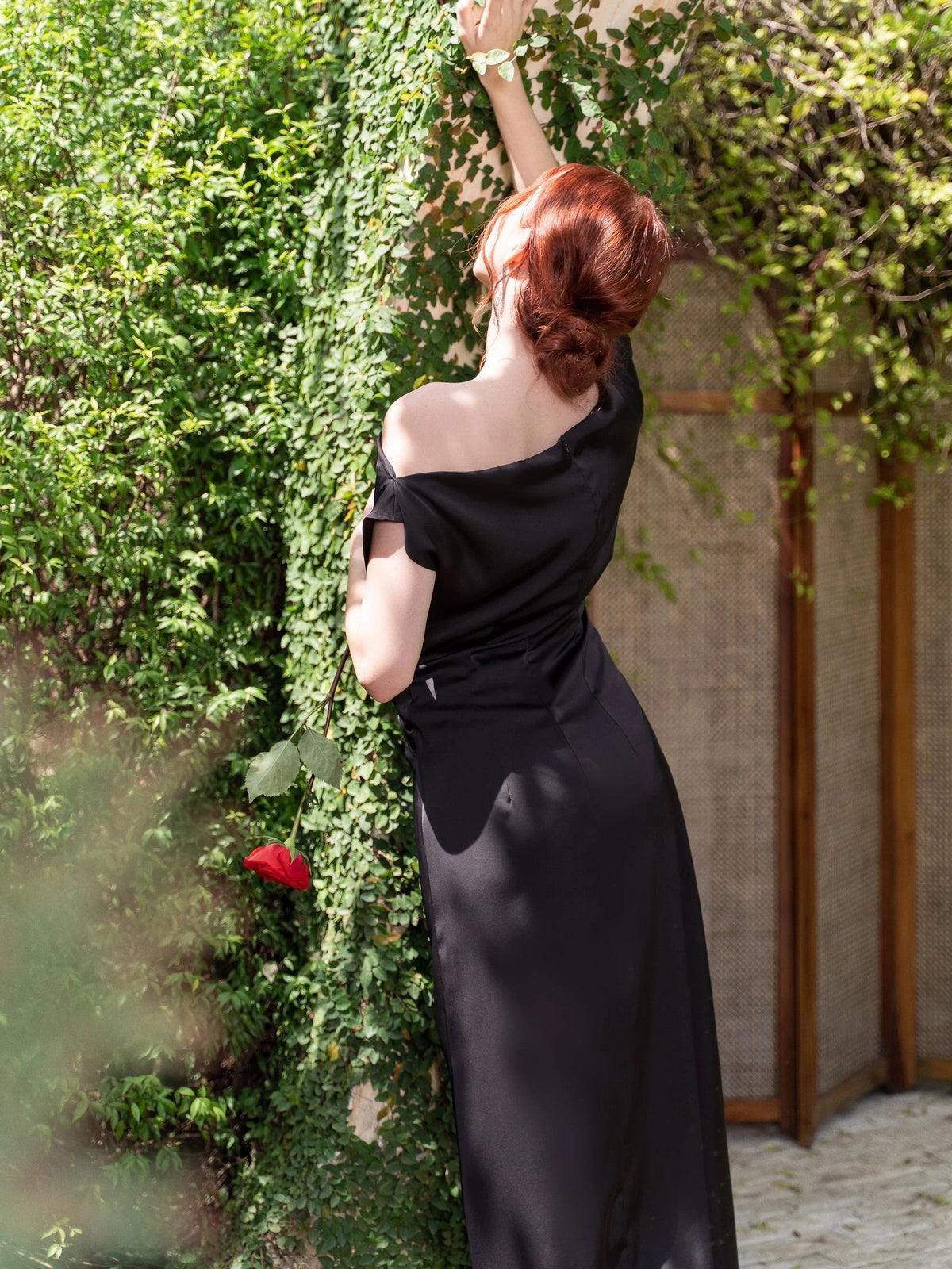 Black off-shoulder satin maxi prom dress with draped front and side slit