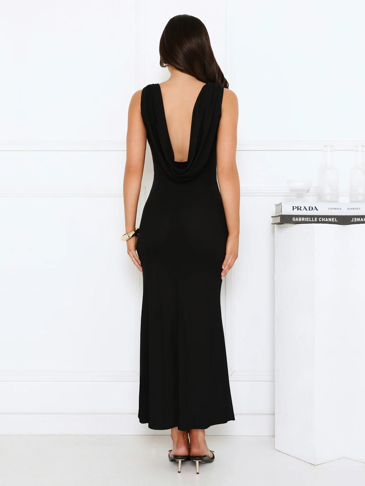 Black sheath maxi formal dress with open back, full-length back view