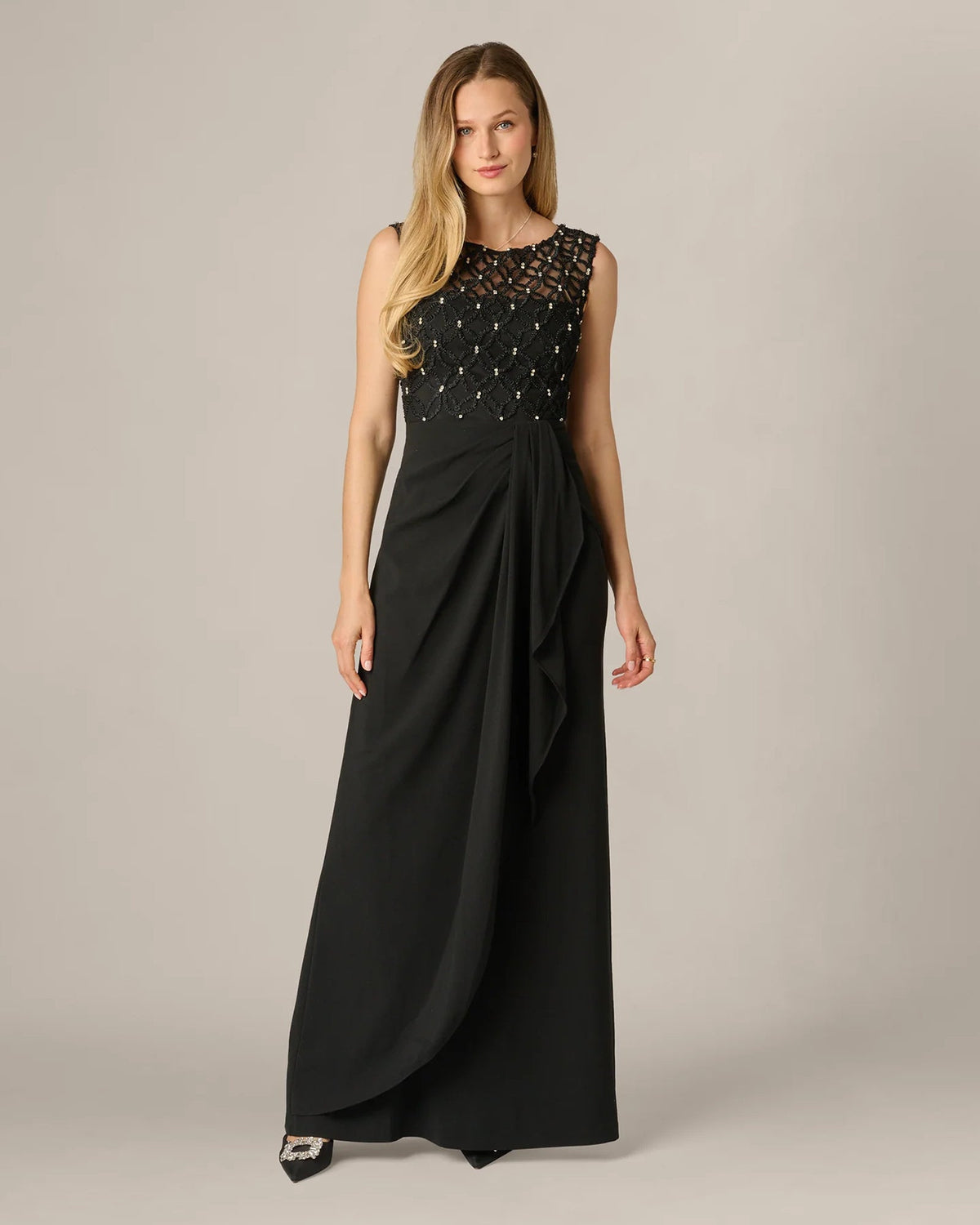 Black sleeveless maxi dress with lace bodice and draped pleats A-line skirt