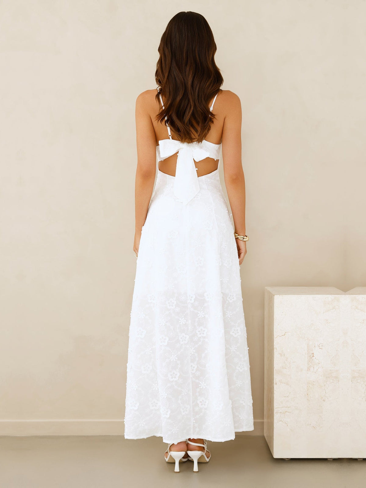 White a-line maxi formal dress with cutout detail, full-length back view