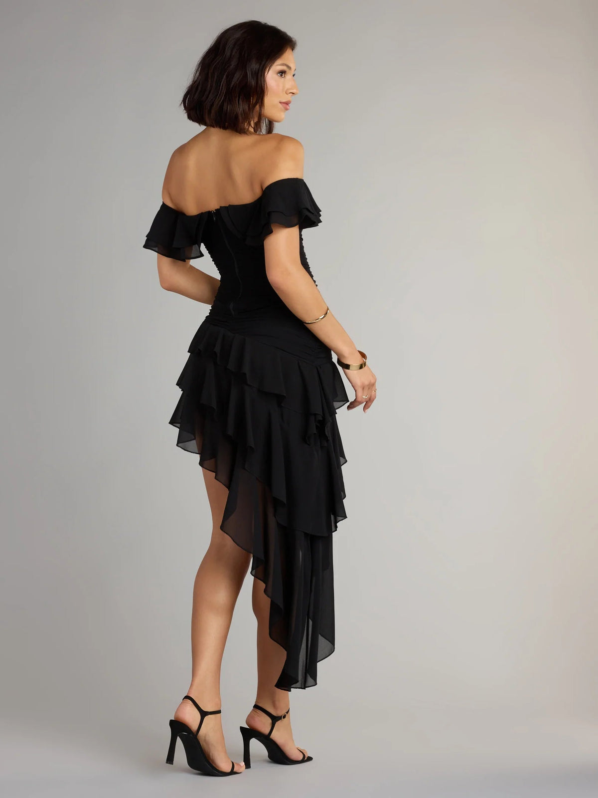 Black off-shoulder ruffled mini chiffon dress with layered tiers, side view