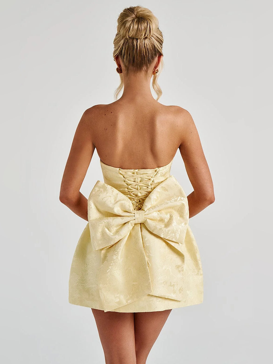 Lemon strapless mini homecoming dress with ruched corset back and bow center