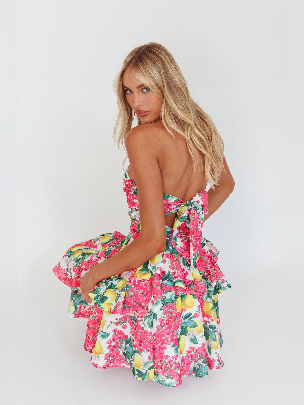 Layered mini dress with pink lemon floral print; strapless back with tiered ruffles