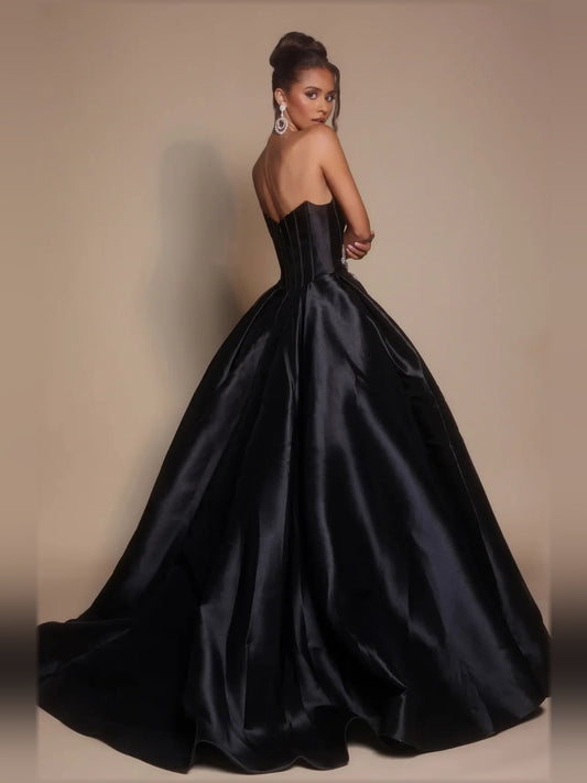 Black strapless satin ball gown with open back and rhinestone waist detail