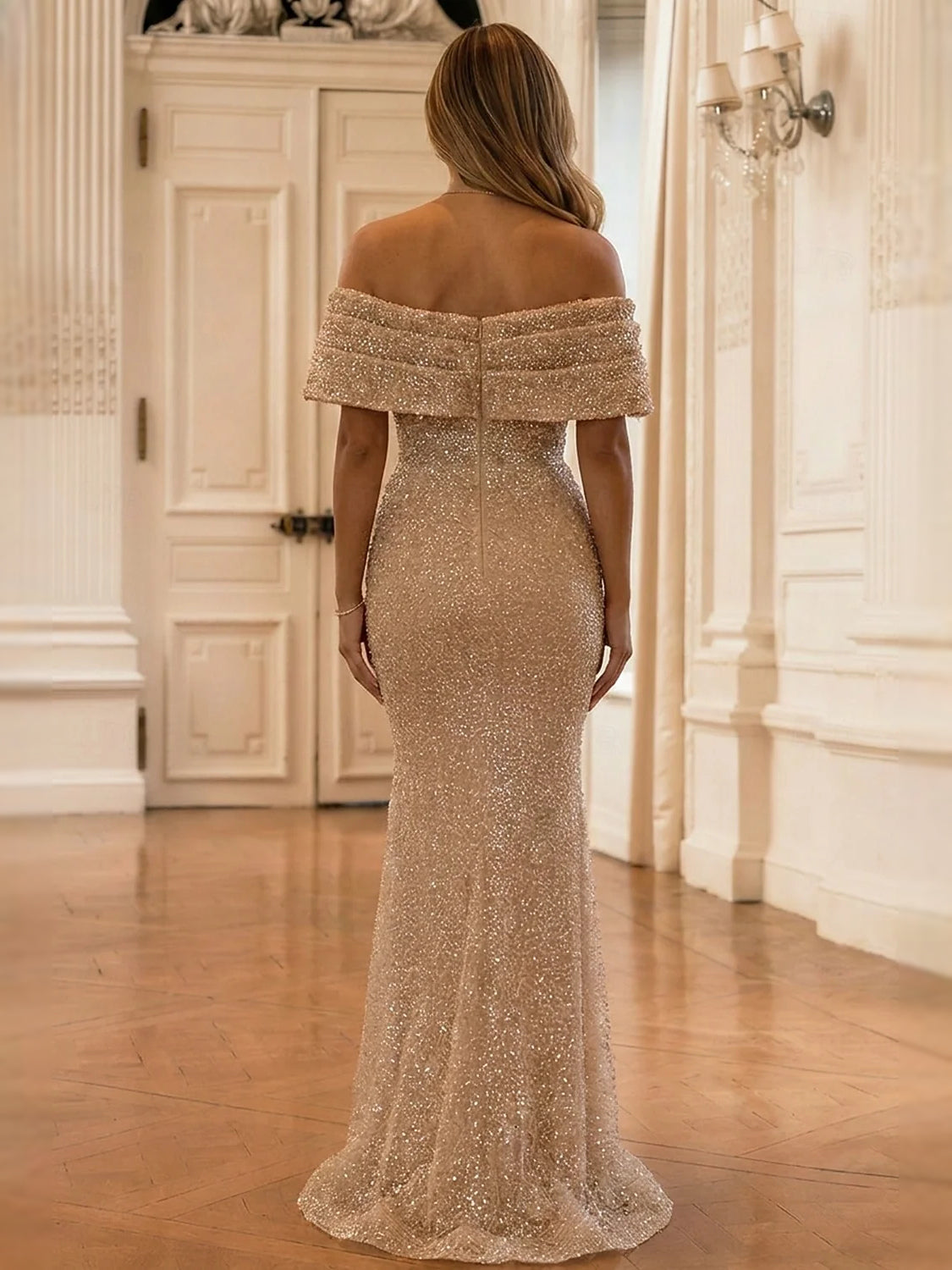 Gold off-shoulder mermaid maxi dress viewed from back, ruched seams and ruffled off-shoulder