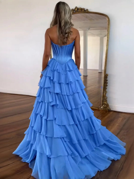 Blue strapless corset prom dress, tiered ruffle skirt shown from the back.