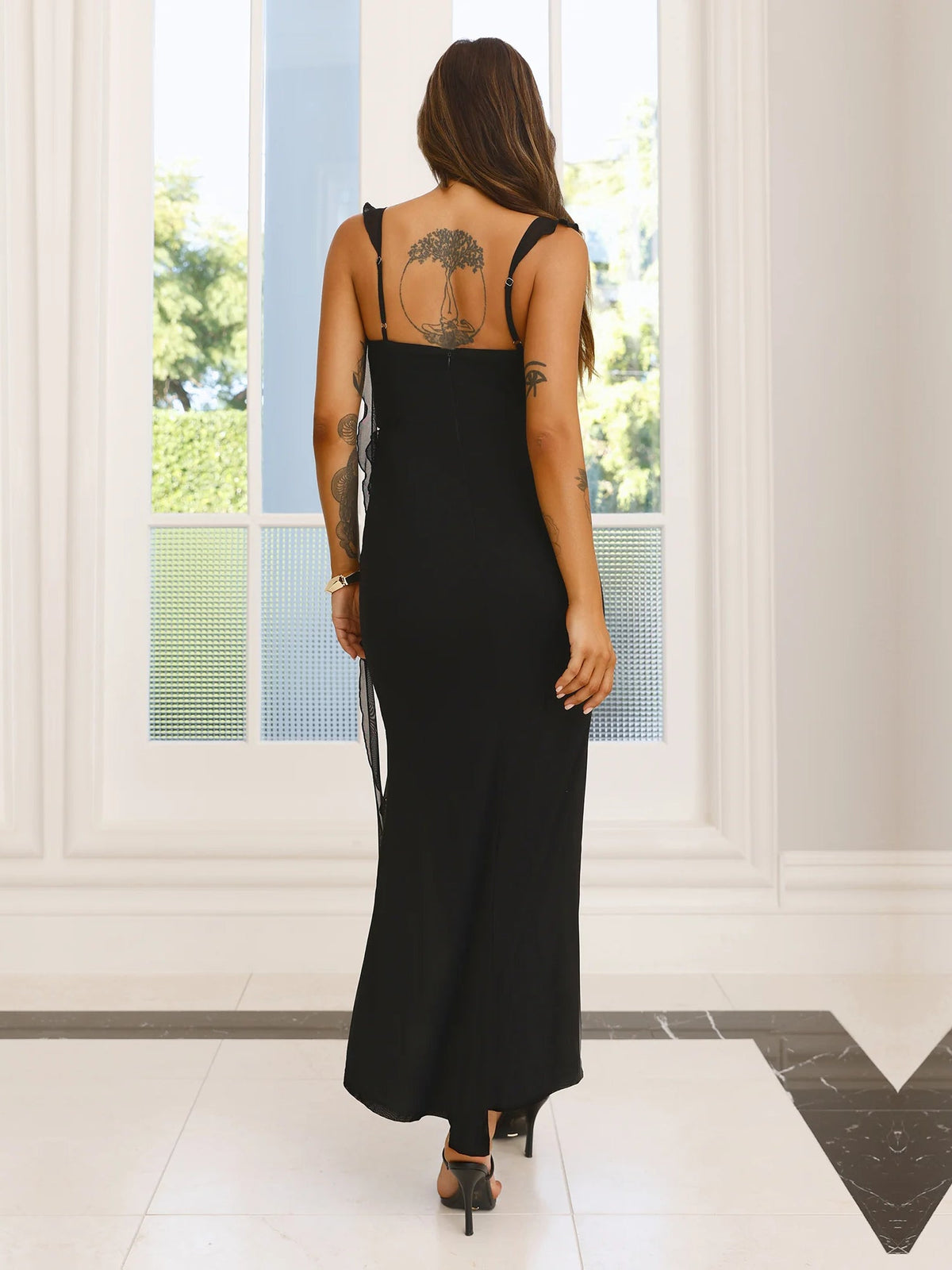 Black sheath maxi formal dress with skirt slit, full-length back view