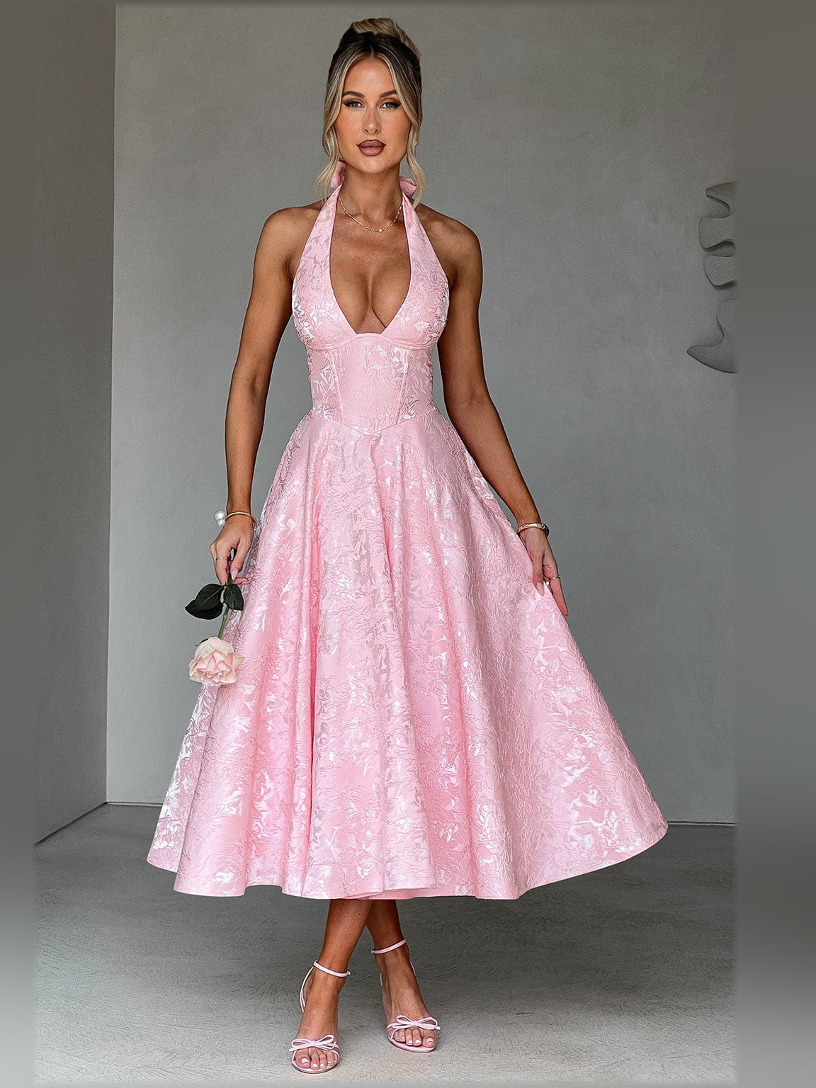 Blush halter midi formal dress with deep V neckline and full gathered skirt, backless style