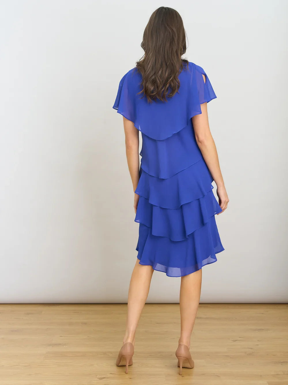 Cobalt blue V-neck tiered chiffon knee-length dress from back view with layered ruffles