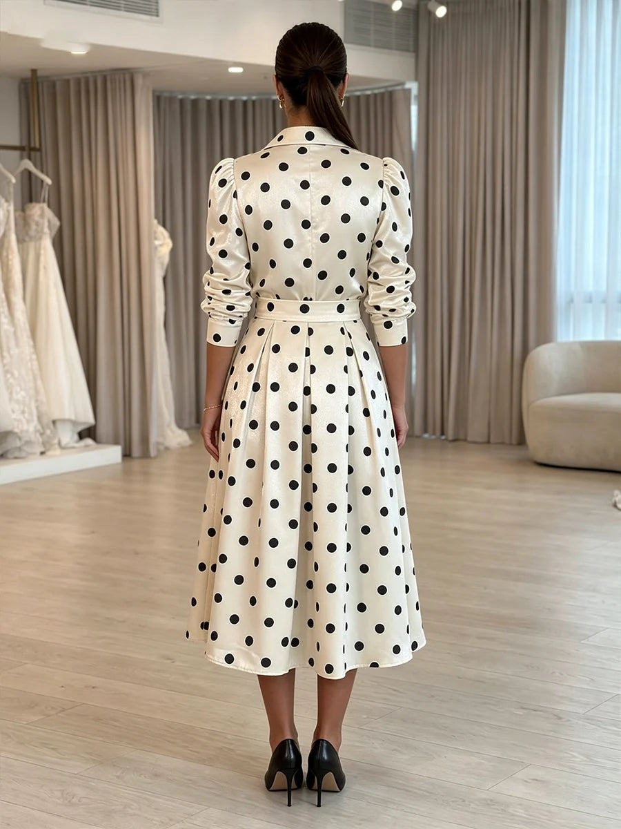 White satin midi dress back view with black polka dots, long sleeves, belted A-line skirt