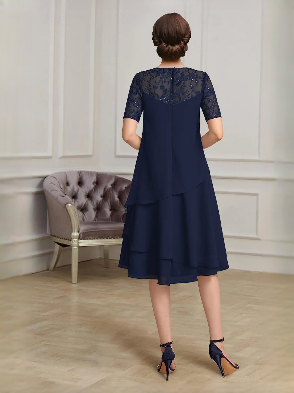 Navy blue chiffon midi dress with lace back yoke, short sleeves, and tiered A-line hem.