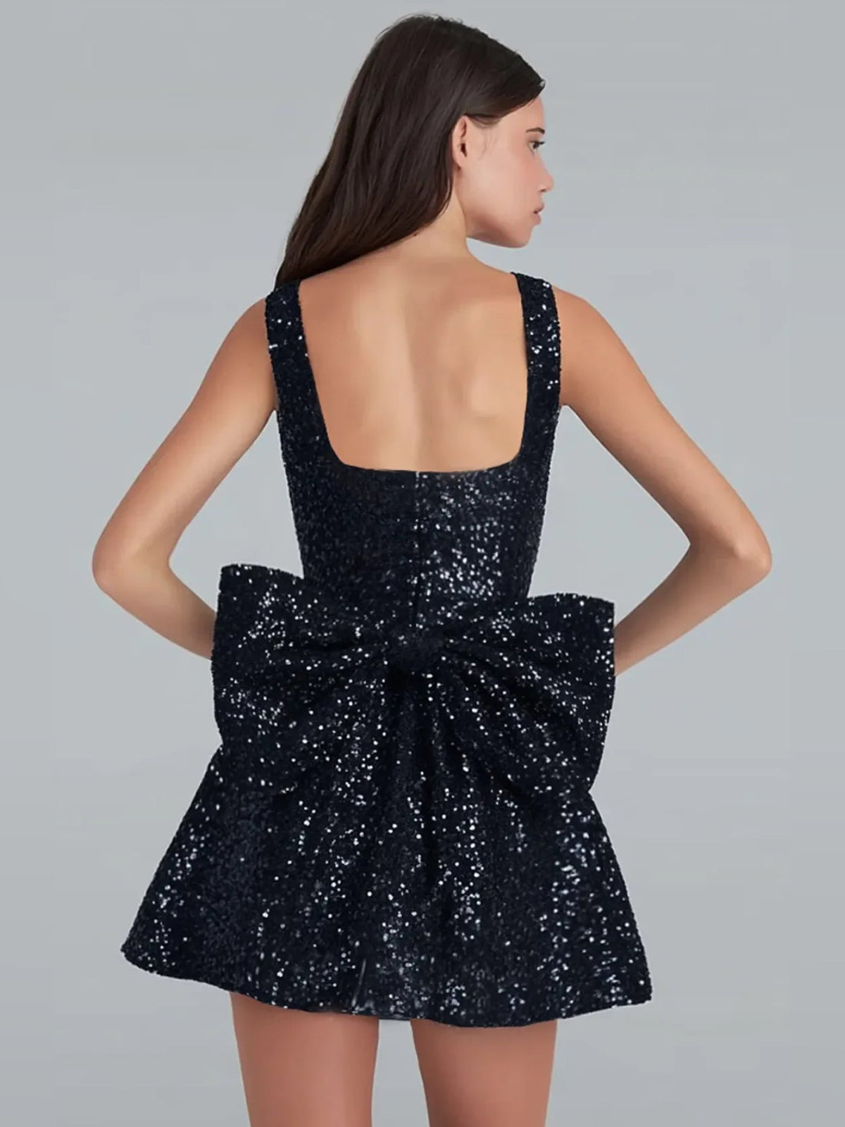 Black sequin A-line mini dress with square back and large bow detail