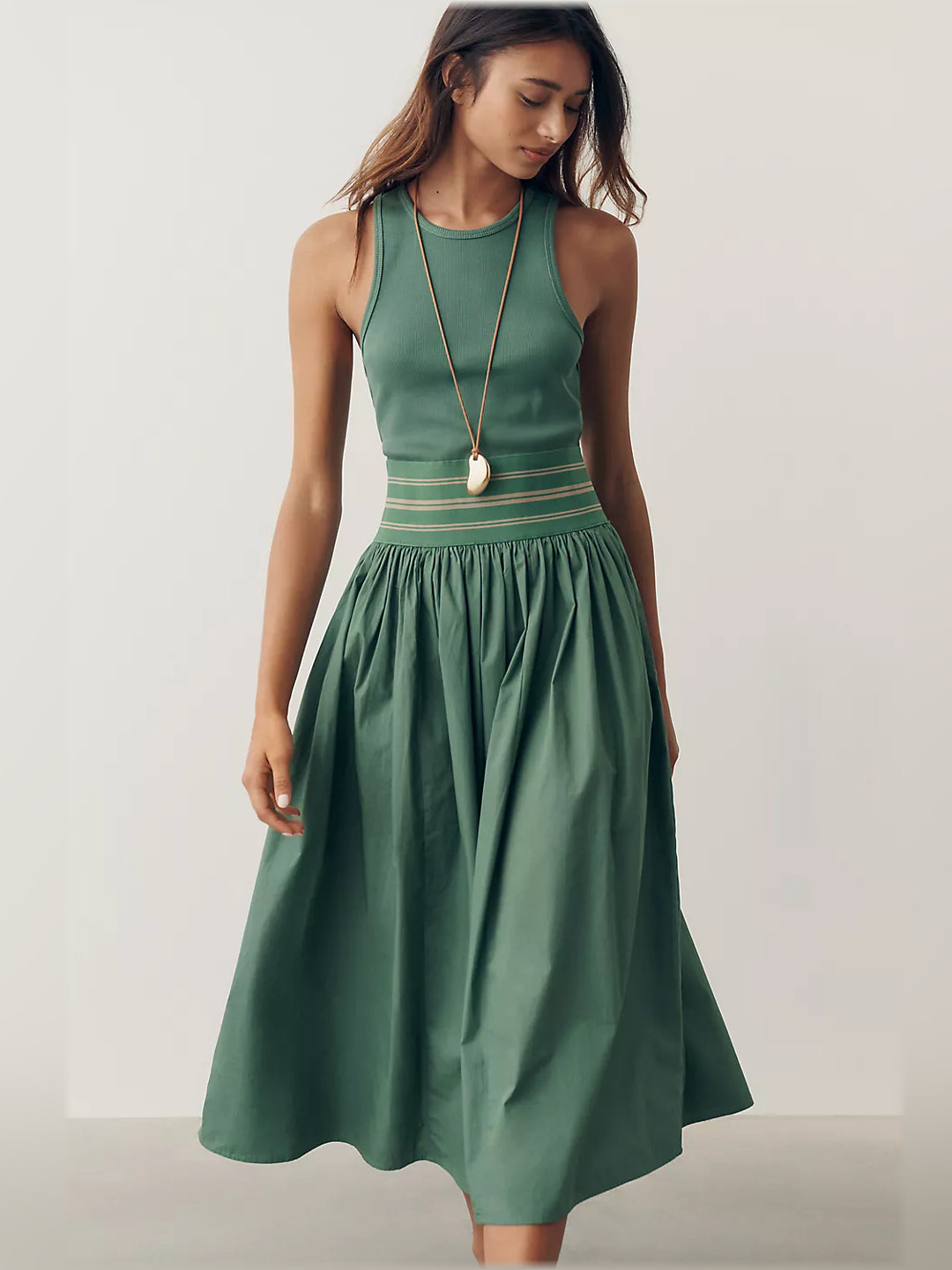 Green sleeveless midi dress with horizontal band at waist and gathered skirt