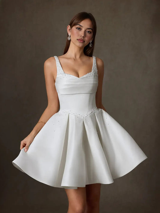 White satin sweetheart mini wedding dress with pleated A-line skirt and sparkle bodice