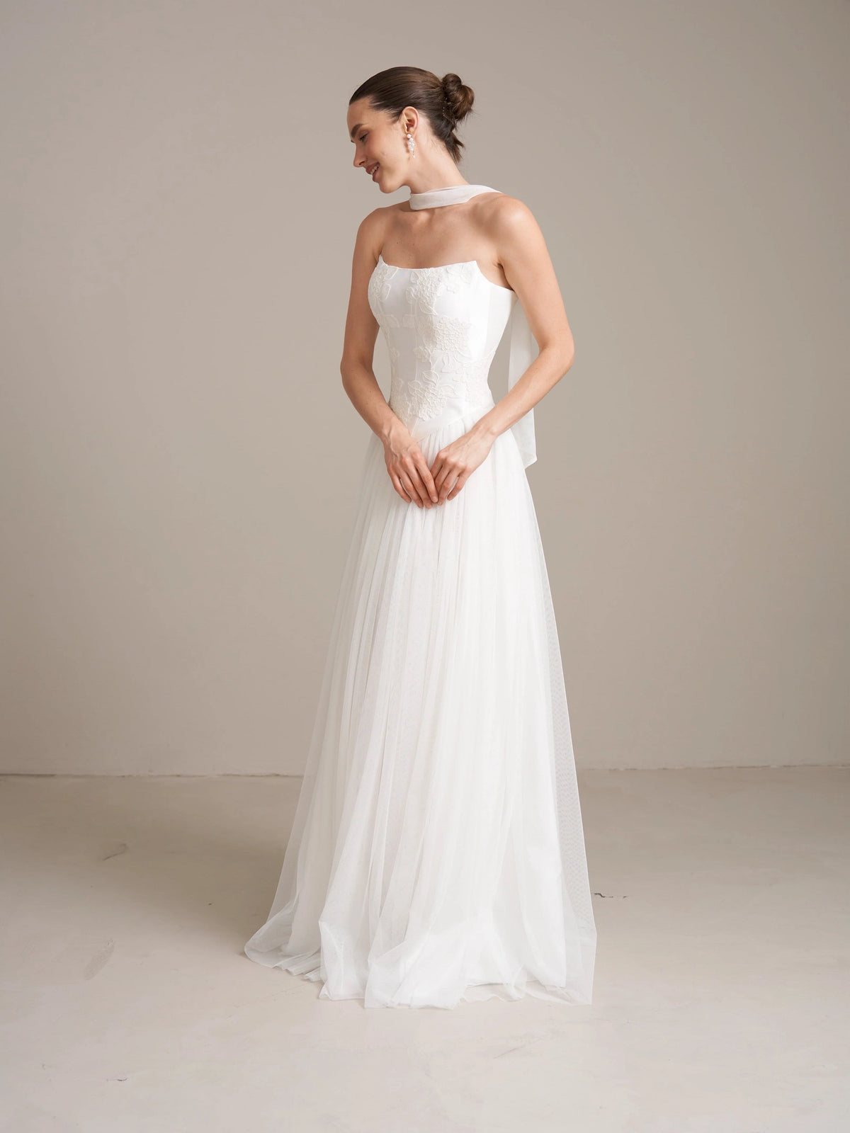 Ivory strapless corset wedding dress with A-line tulle skirt, side profile