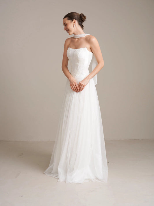Ivory strapless corset wedding dress with A-line tulle skirt, side profile