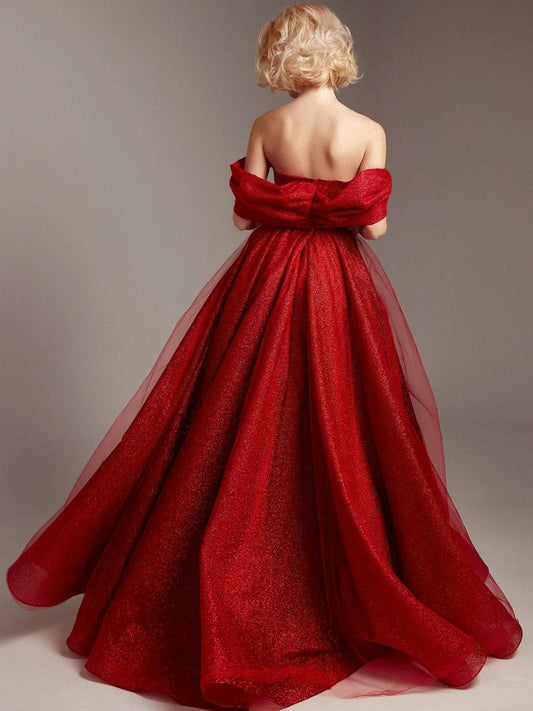 Red strapless corset formal dress with puff sleeves, open back, and full floor skirt