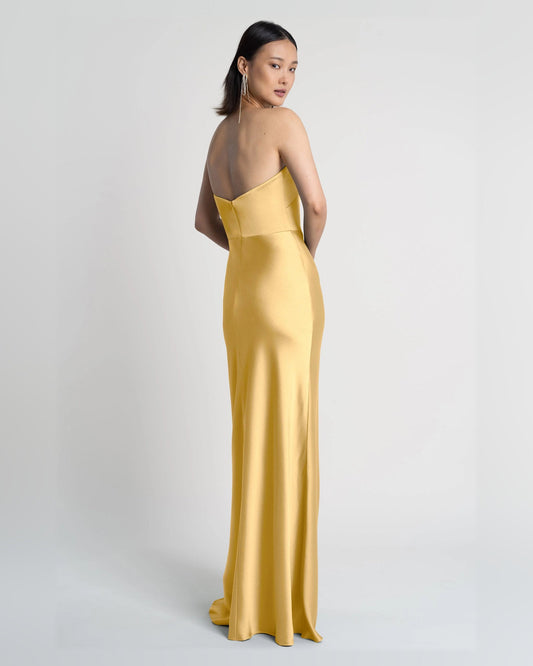 Strapless A-line maxi dress in satin gold, side view, fitted bodice and flowing skirt