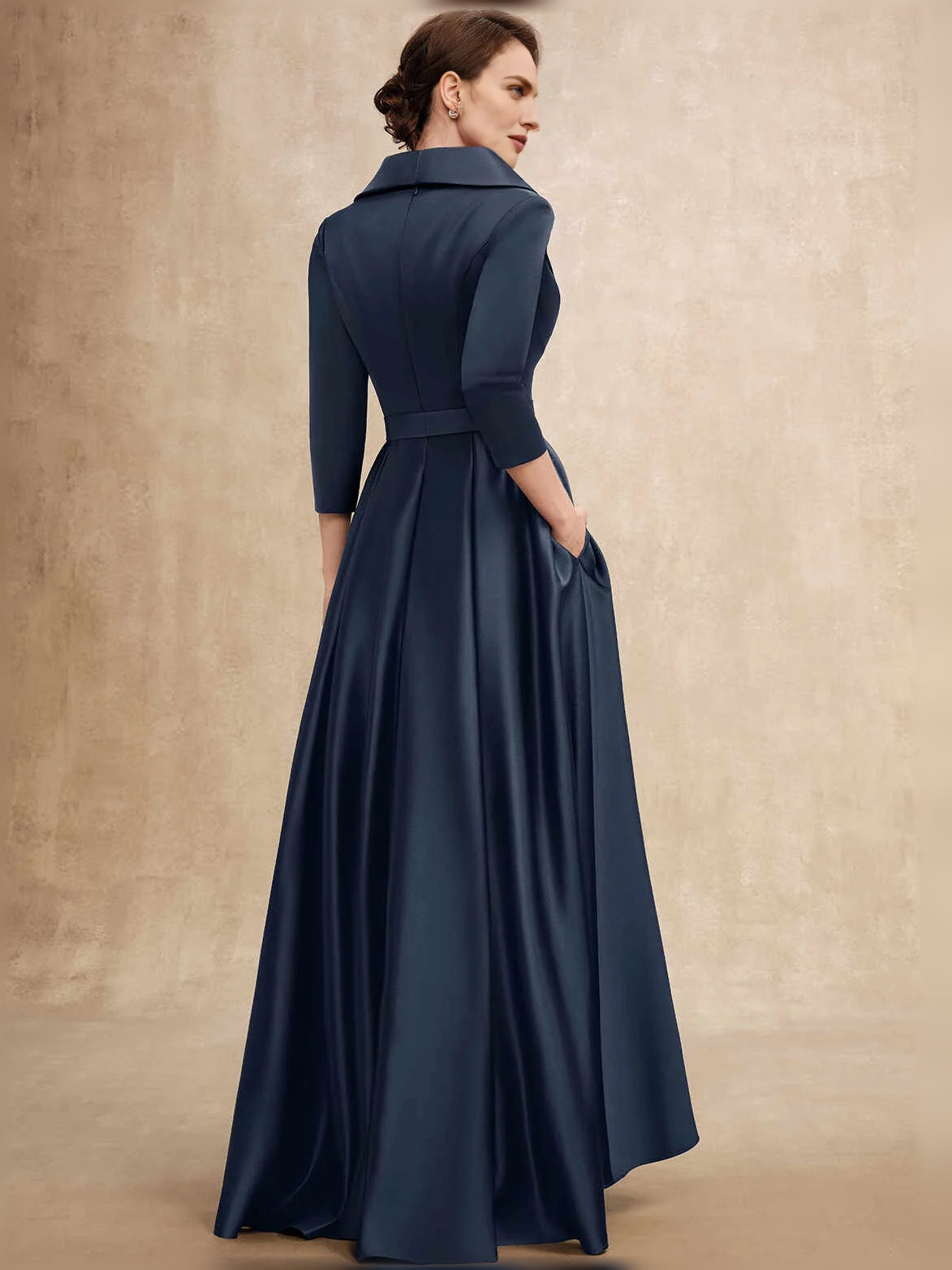 Dark navy satin A-line mother-of-the-bride dress, back view with sash tie and high-low hem