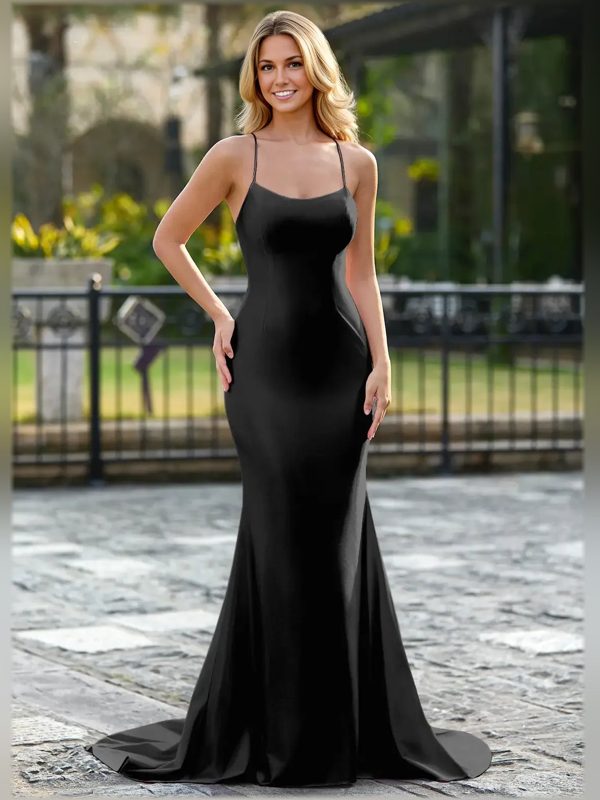 Black floor-length formal dress with spaghetti straps and fitted mermaid silhouette