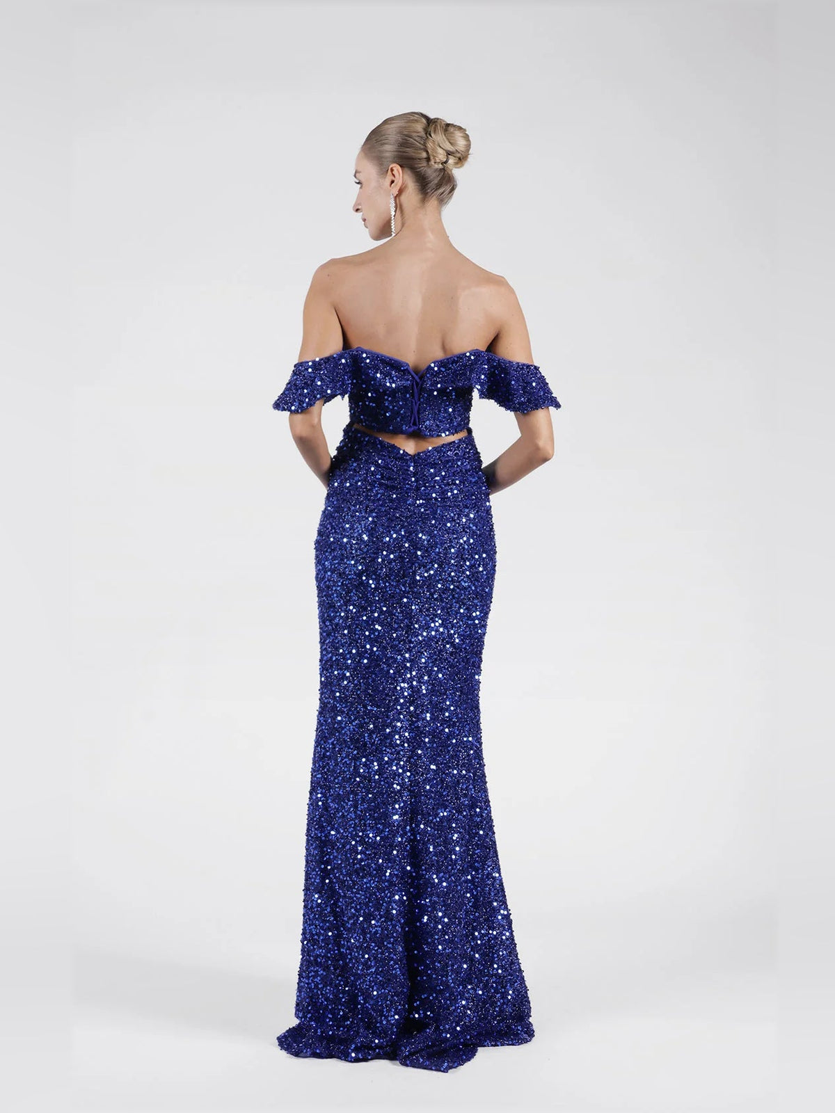 Dark blue sequin off-shoulder mermaid gown from the back, with high slit