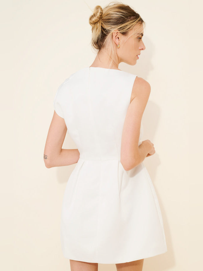 White sleeveless mini dress from back view with fitted waist