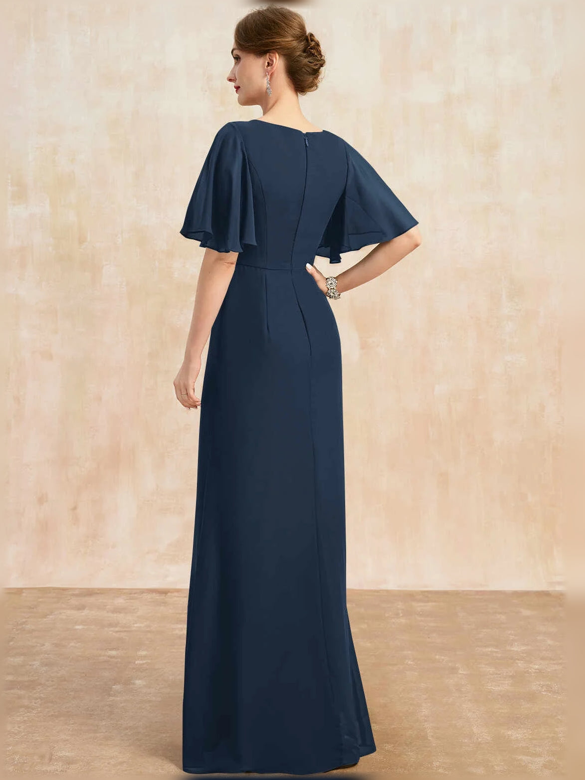 Dark navy floor-length draped sheath dress with short flutter sleeves, gathered back